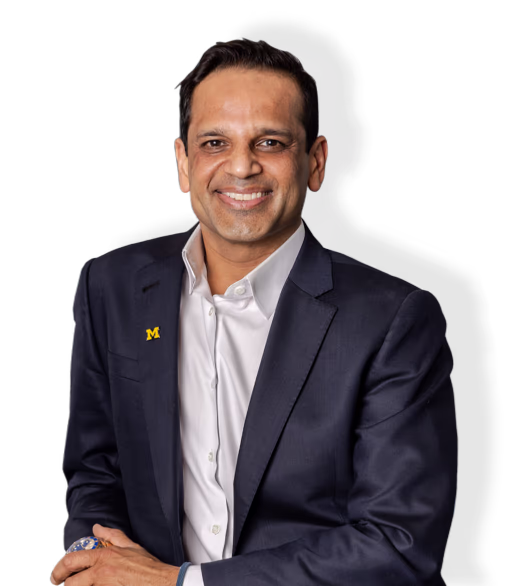 Man in suit smiling against white background