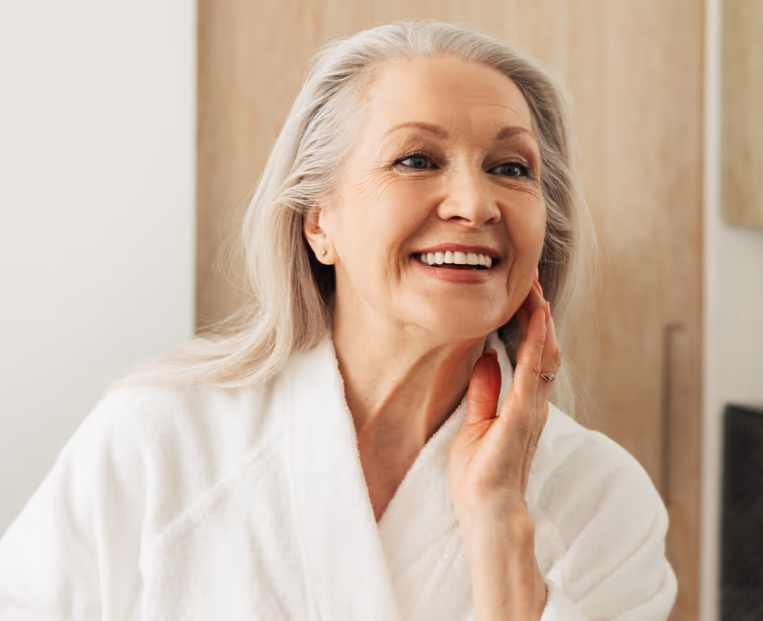 Elderly woman smiling in cozy environment