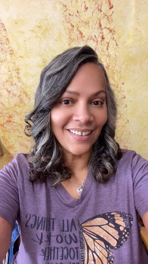 Smiling woman in purple blouse indoors