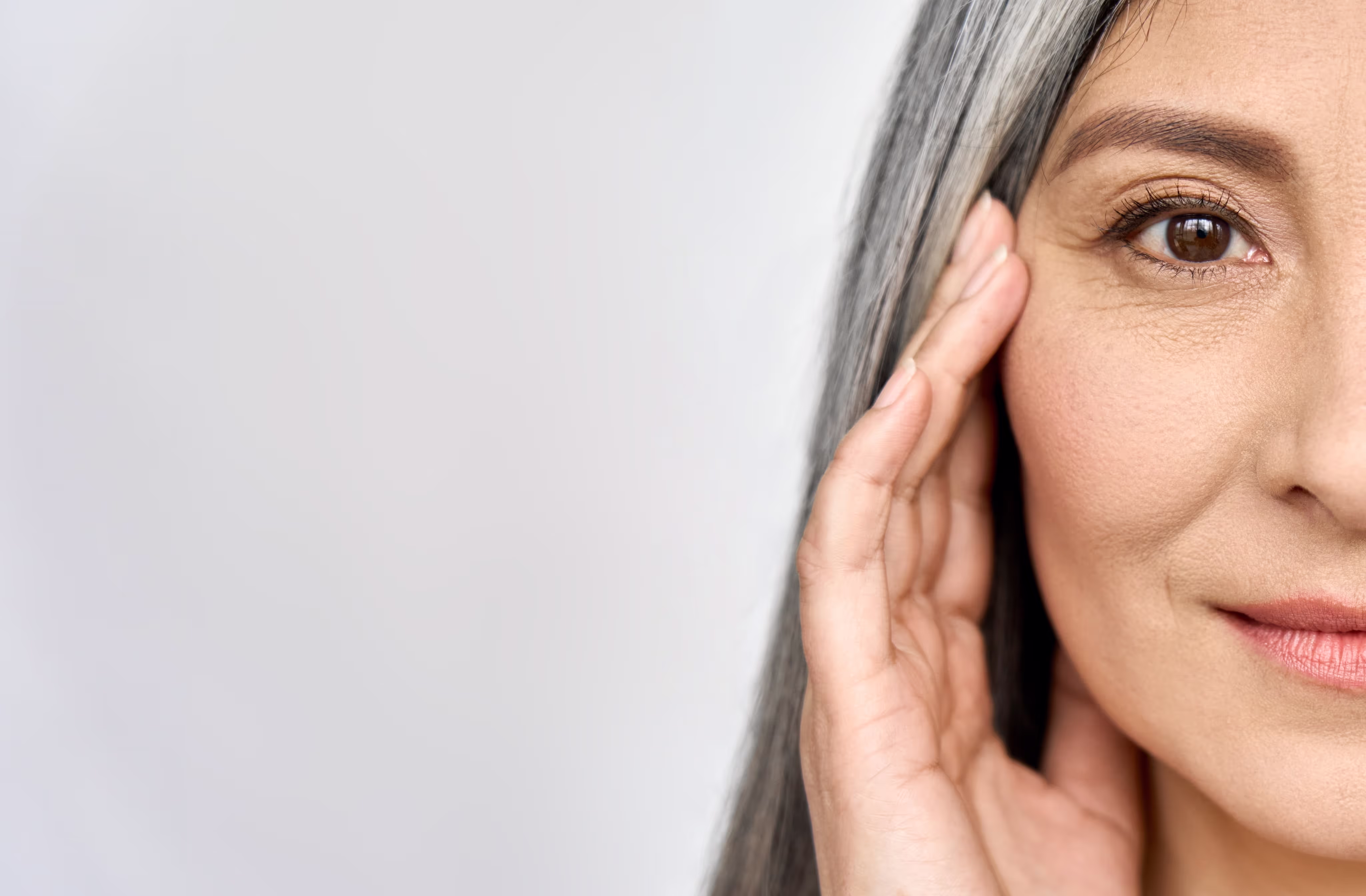 Close-up of woman touching her face gently