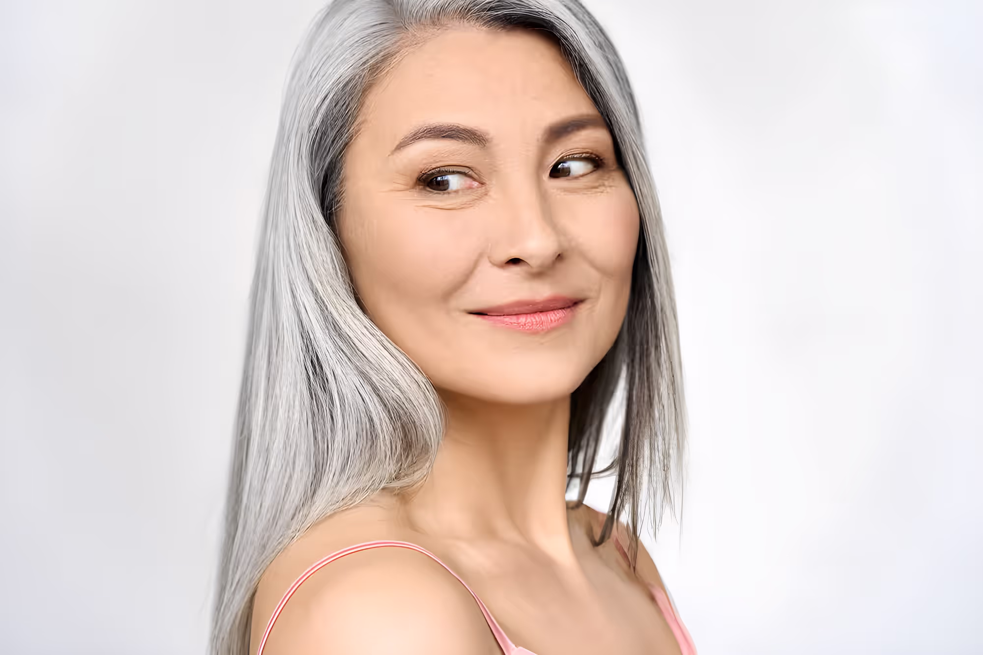 Woman smiling with long silver hair